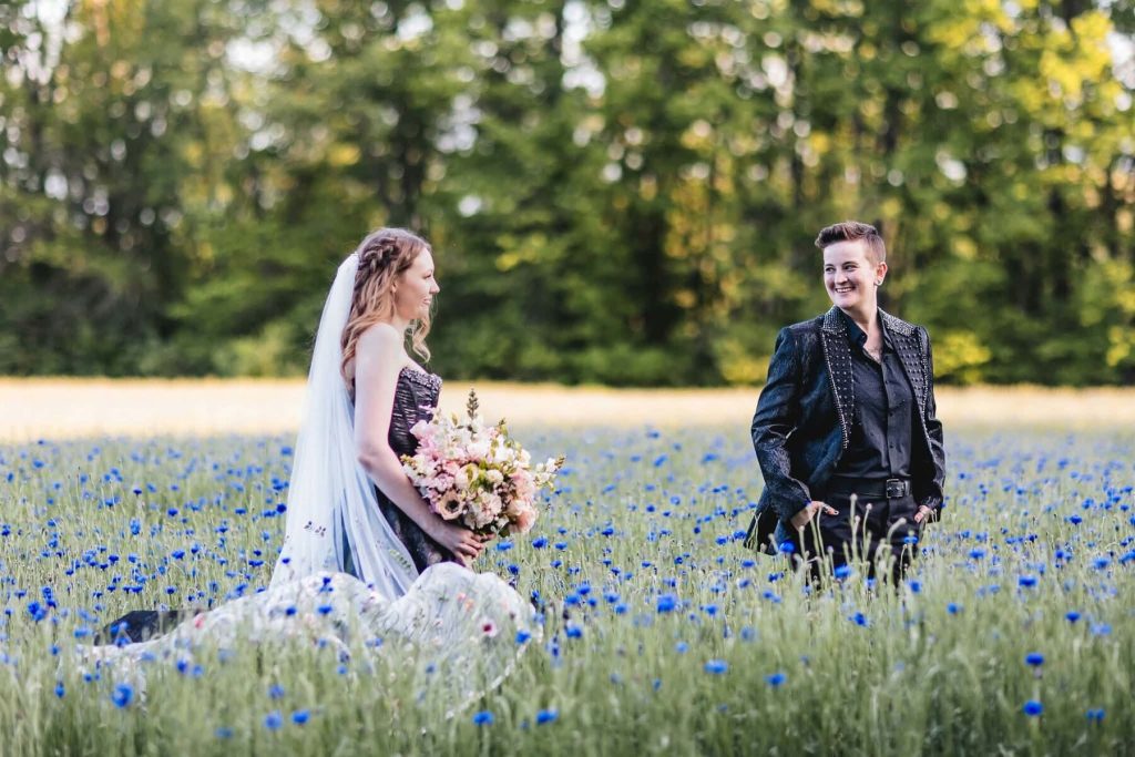 Couple in a field of blue cornflowers on their wedding day in Indiana