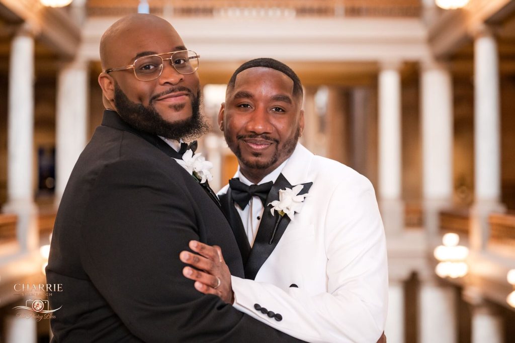 Two grooms embracing inside the Indiana Statehouse on their wedding day